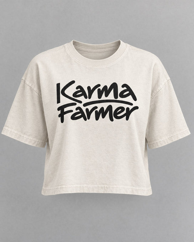 The bone Signature Crop Tee from the front, with Karma Farmer across the chest in black marker lettering.