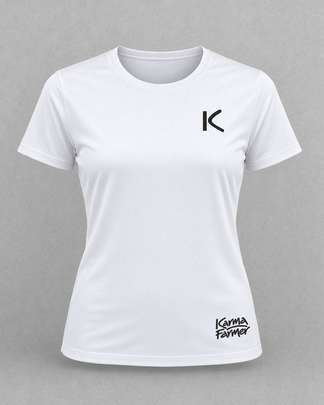 The white women's Court Tee from the front, with a small black K over the heart and a small Karma Farmer signature near the hem.