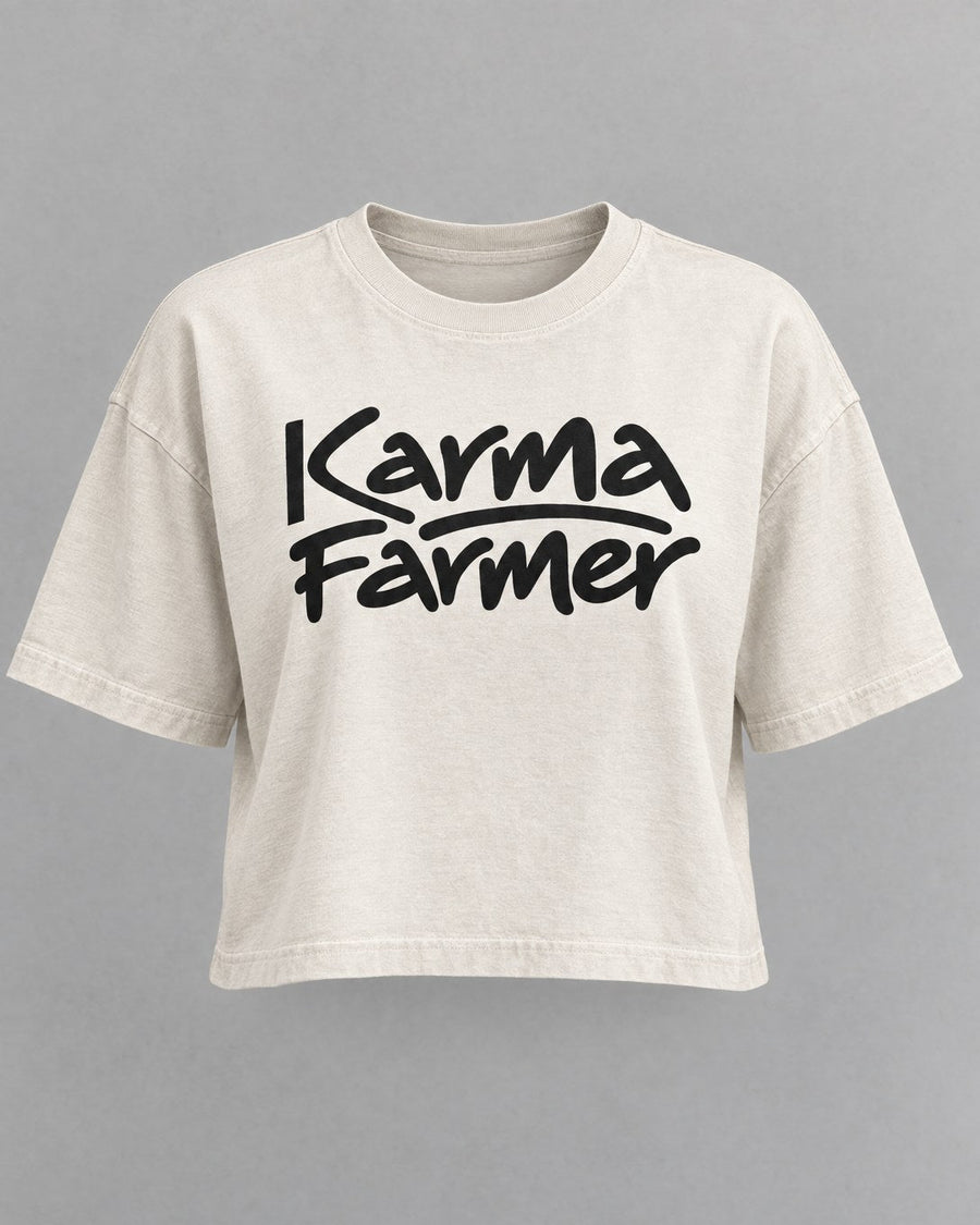The bone Signature Crop Tee from the front, with Karma Farmer across the chest in black marker lettering.