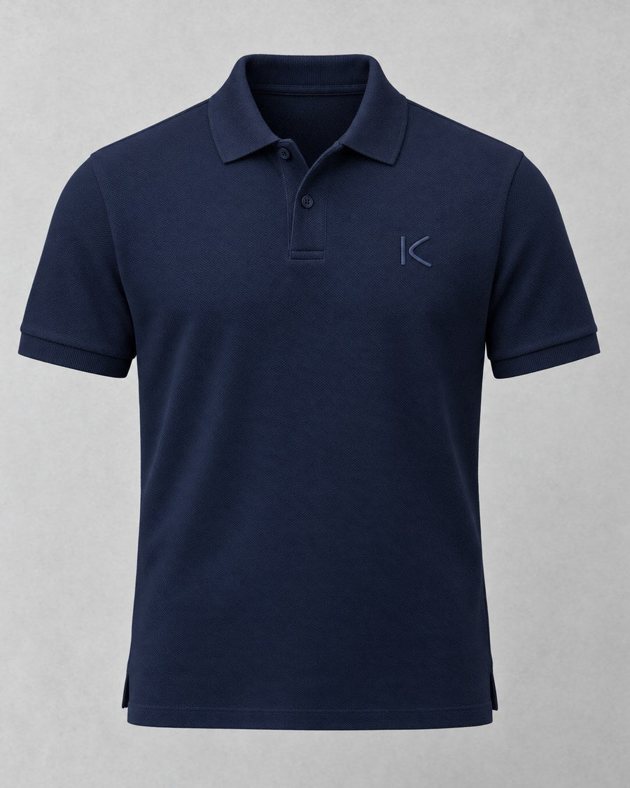 The navy K Polo from the front, with a small navy K stitched on the chest.