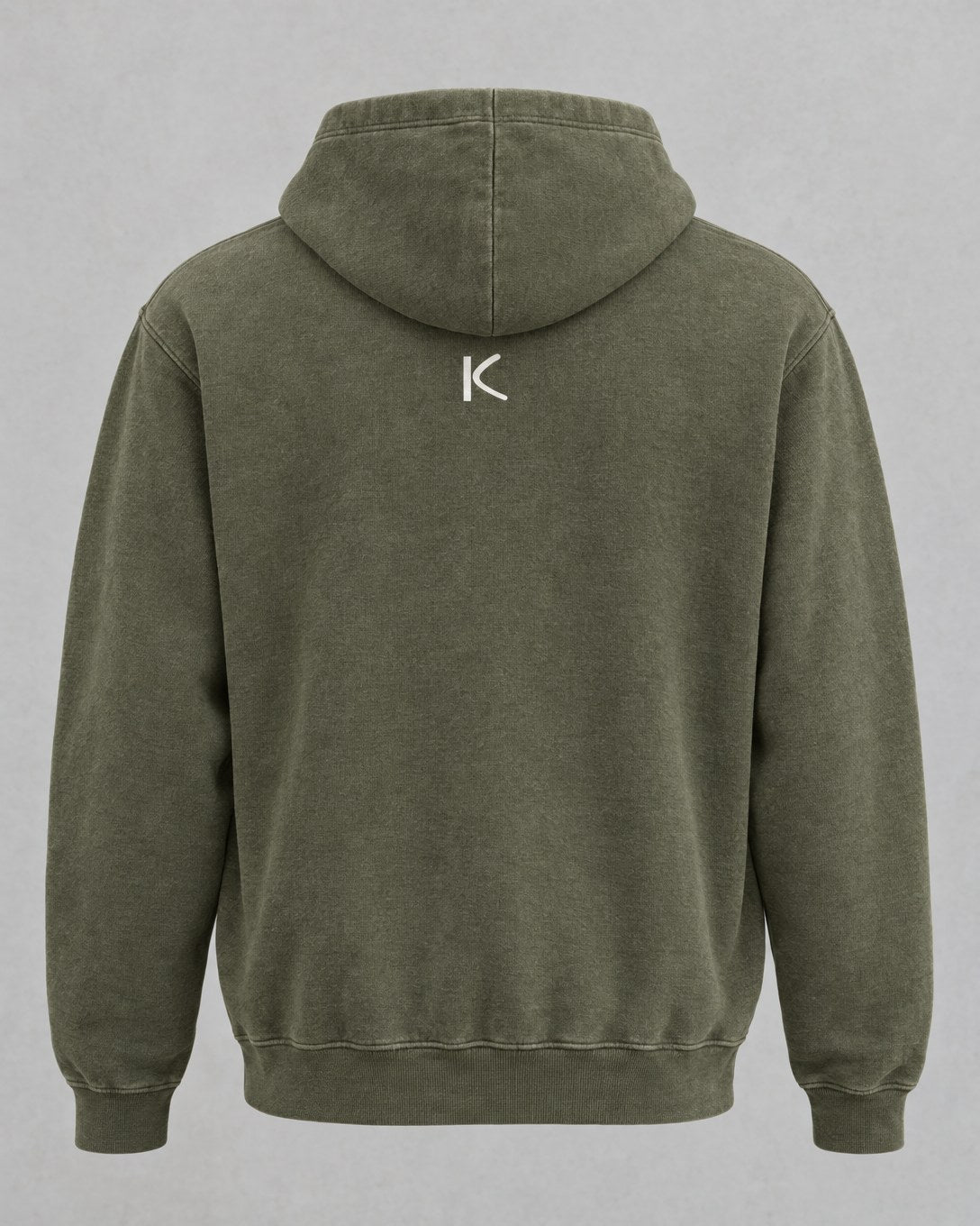 The back of the olive hoodie, plain except for a small chalk-white K below the hood.