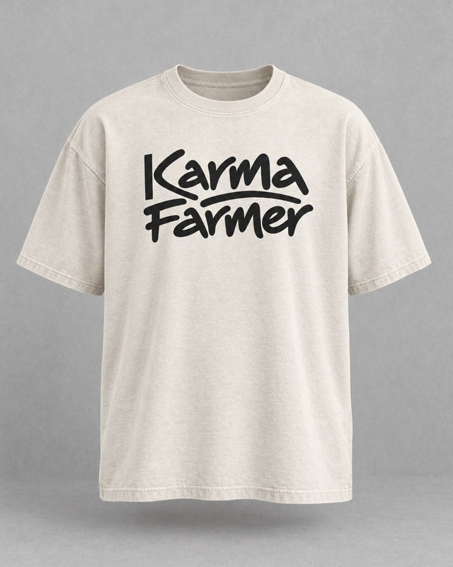 The bone Signature Tee from the front, with Karma Farmer across the chest in black marker lettering.