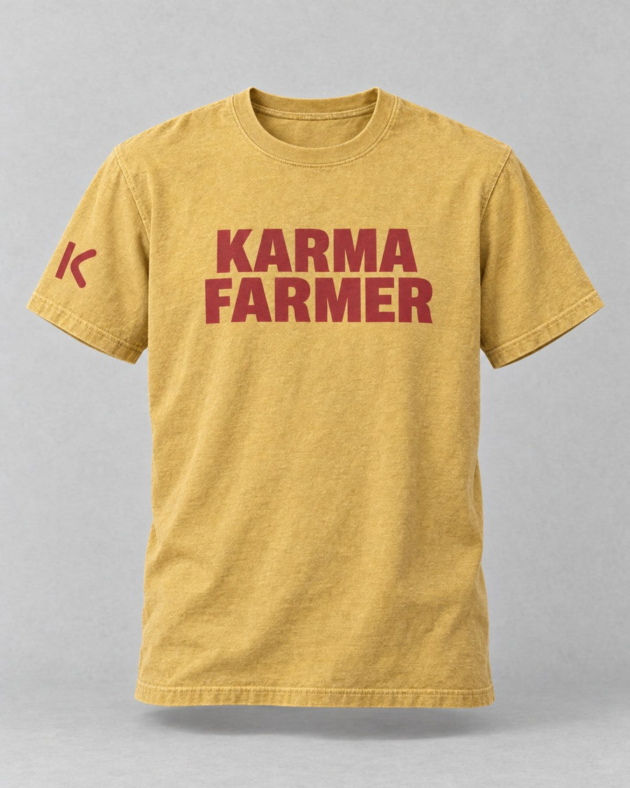The mustard Summer Tee from the front, with KARMA FARMER in brick-red block capitals and a small K on the sleeve.